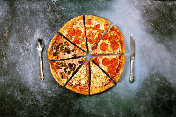 istock Slices of pizza with different toppings on a dark textured background 917379654
