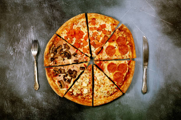 istock Slices of pizza with different fillings on a dark textured background 917379682