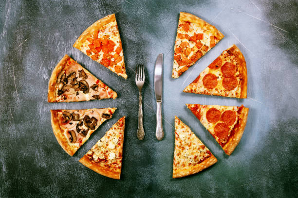 istock Slices of pizza with different toppings on a dark textured background 917379700