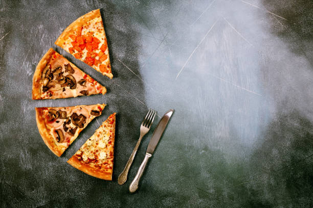 istock Slices of pizza with different toppings on a dark textured background 917379714