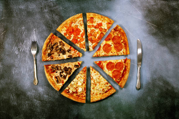Slices of pizza with different toppings on a dark textured background