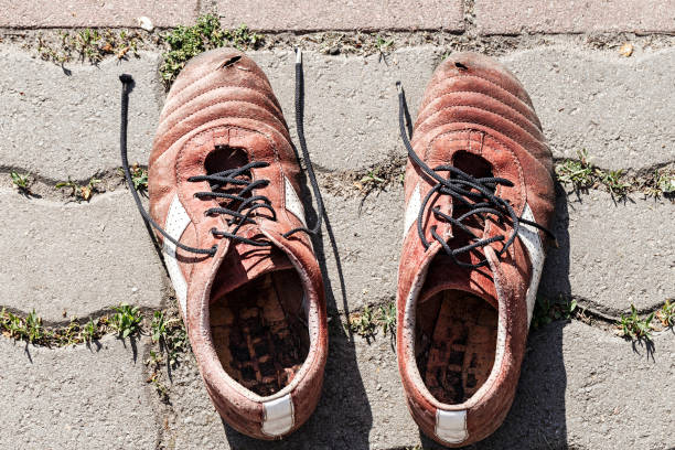 istock old men's sneakers stand on a stone background 917380250