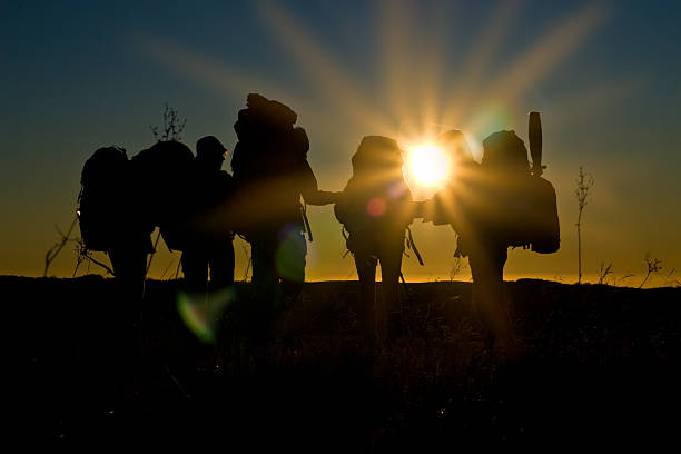 istock Hikers walk in sunset with sunbeams and reflections 91739104