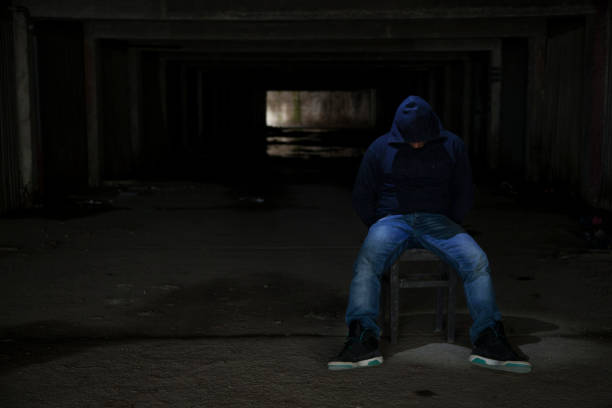 istock Prisoner man in dark room 917391212