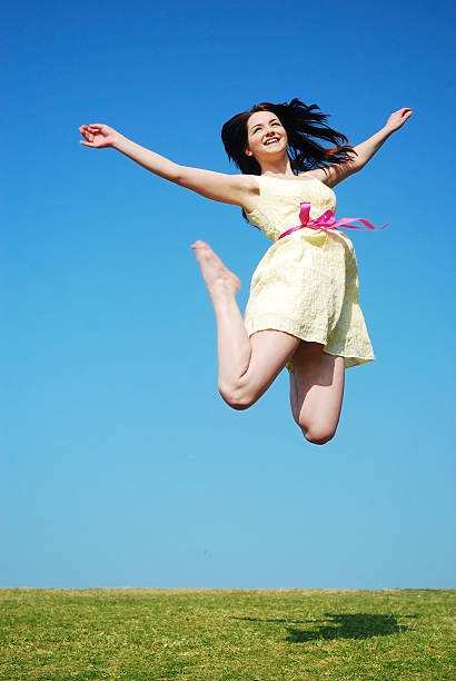 Happy woman jumping stock photo