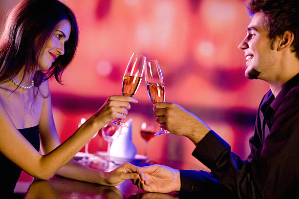 Amorous couple on romantic date or celebrating together at restaurant stock photo