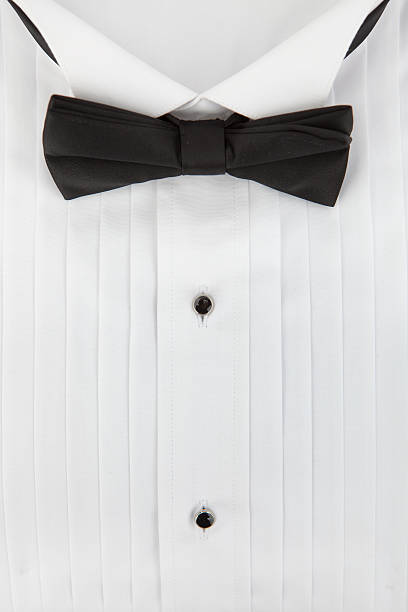 Young minority guy in a tuxedo isolated on white