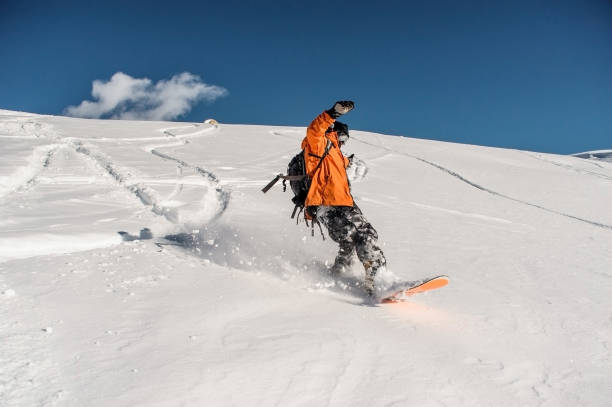 istock Snowboarder riding on the beautiful snow slope 917397222