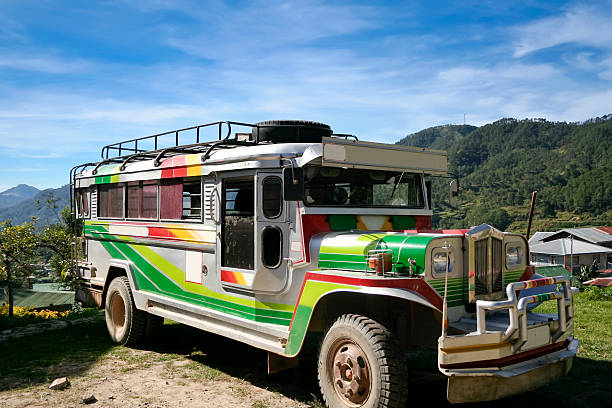 A jeepney is parked in downtown Manila, Philippines on a sunny day.