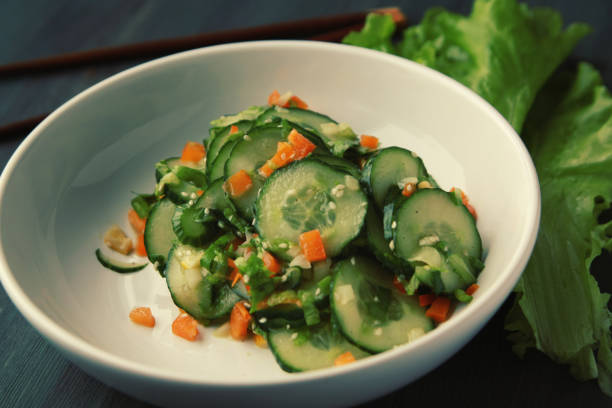 istock Asian cucumber salad on the white plate. Close up. 917402458
