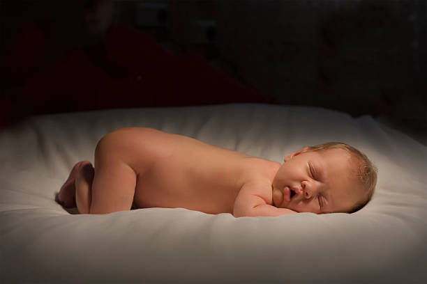 Baby Sleeping on white blanket stock photo