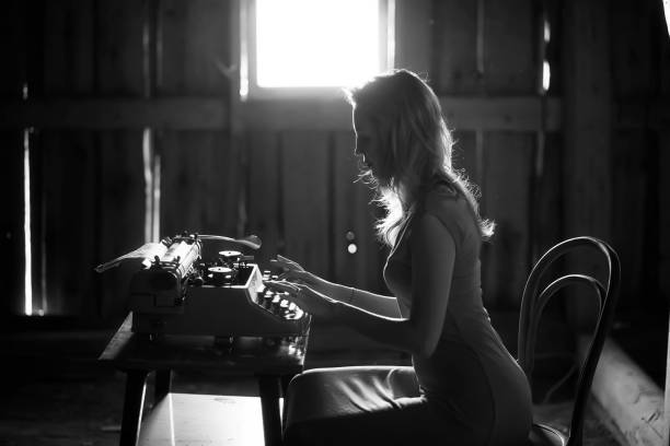 istock A girl prints on an old typewriter 917403268