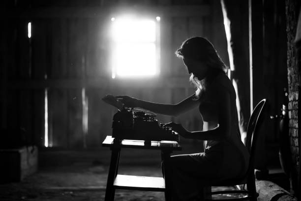istock A girl prints on an old typewriter 917403562