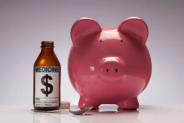 Photo of Credit cruch piggy bank with medicine