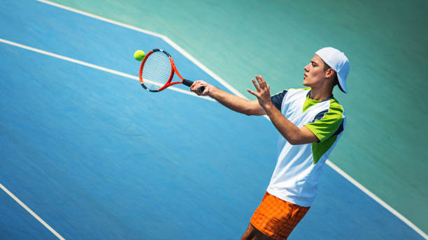 young man playing tennis. - tennis court tennis racket forehand imagens e fotografias de stock
