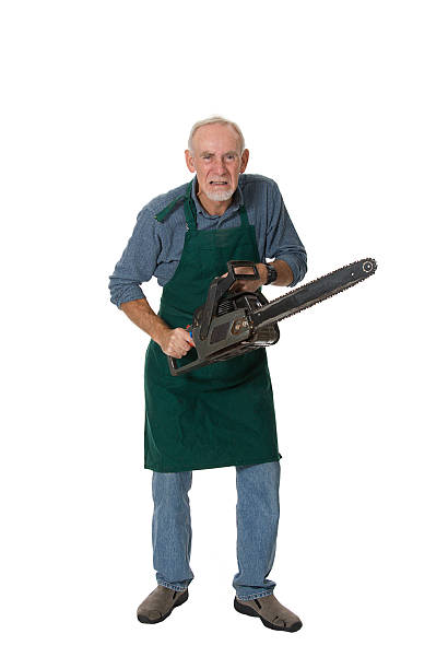 Crazy old man with chainsaw stock photo