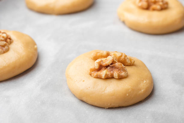 istock Raw honey biscuits with walnuts on a baking sheet with parchment paper, ready for baking. home cooking 917414252