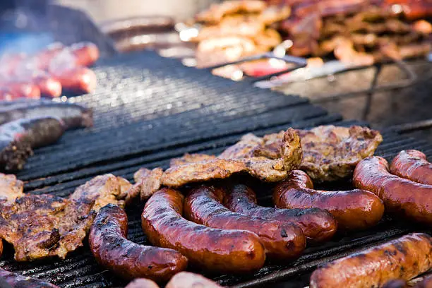 Photo of Sausage and meat on barbequeue