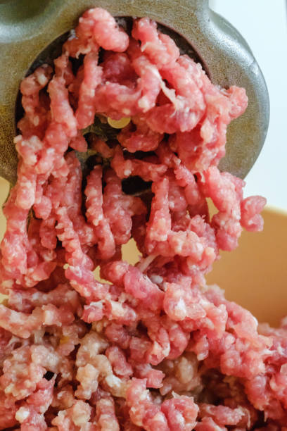 istock Close up meat grinder or mincing-machine with mincemeat in. Showing the forcemeat process. 917420330