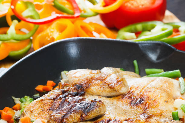 istock Whole appetizing grilled chicken on grill pan with vegetables 917420538