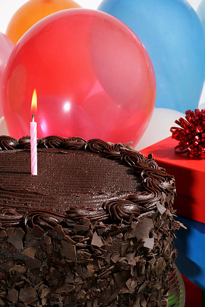 istock Lighting Candle on a Chocolate Birthday Cake 91742148