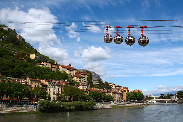 Cable car in Grenoble, France The gondola type of cable car of spherical form taking passengers from the center of city to the 19th century Fort de Bastille on top of a hill over the Isere river is one of the symbols of Grenoble, France. isere river stock pictures, royalty-free photos & images