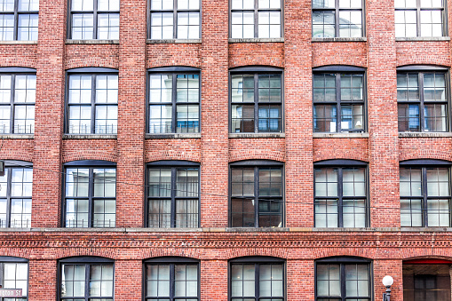 Pattern of brick glass window building in Brooklyn, NYC, New York City, front exterior grunge old architecture