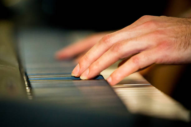 istock Close up male hands playing electric piano 917427242