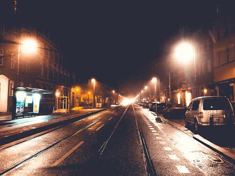 train rails in a street at night