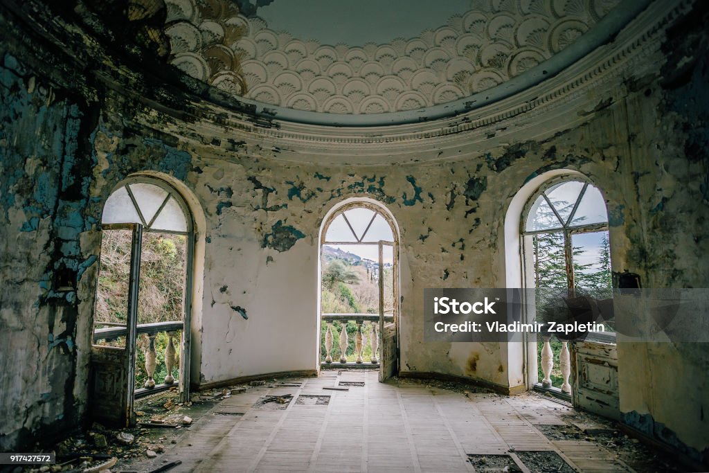 Old ruined abandoned mansion, interior of round hall Old ruined abandoned mansion, interior of round hall. Mansion Stock Photo