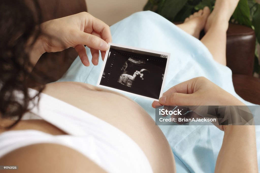 Pregnant woman with ultrasound scan  Feet Up Stock Photo