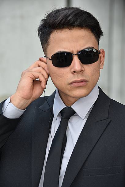 istock Serious Colombian Security Guard Surveillance Agent Wearing Sunglasses 917431788