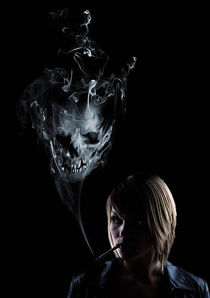 istock young women smokes with a skull in the smoke 91743726