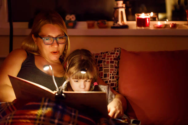 istock Mother reading a bedtime story to her daughter 917440408