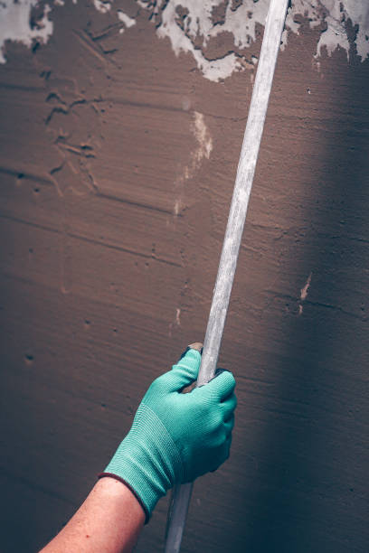 istock Tool for leveling walls in the hands of a worker, feather edge 917444220