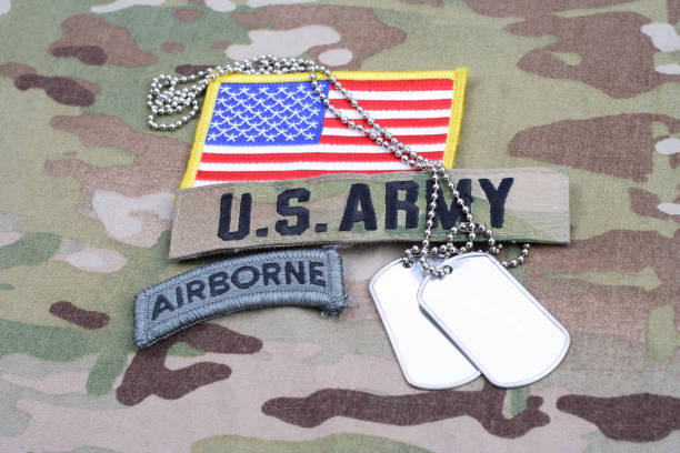 istock US ARMY airborne tab, flag patch, with dog tag on camouflage uniform 917444328