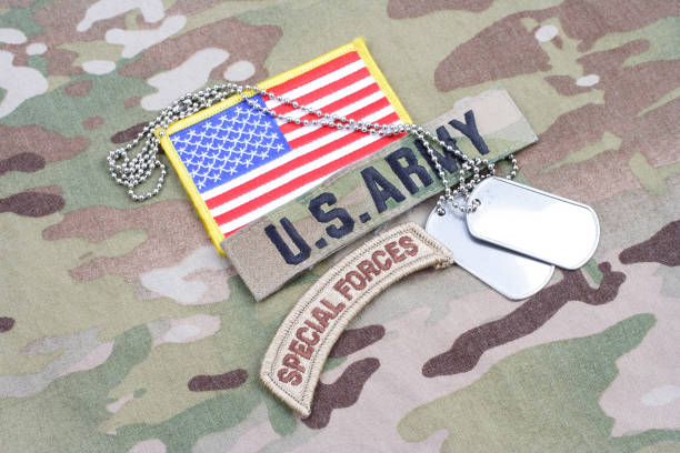 istock US ARMY special forces tab, flag patch, with dog tag on camouflage uniform 917444456