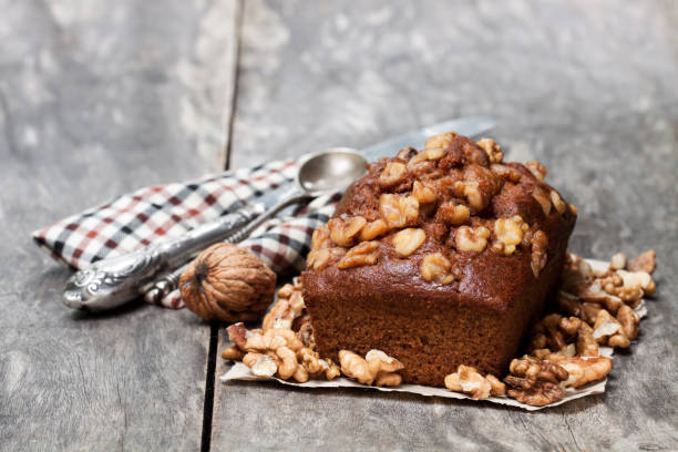 istock Homemade  date and walnut loaf cake on old wooden table 917444486