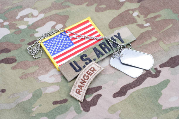 istock US ARMY ranger tab, flag patch, with dog tag on camouflage uniform 917444494