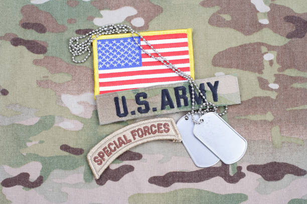 istock US ARMY special forces tab, flag patch, with dog tag on camouflage uniform 917444576