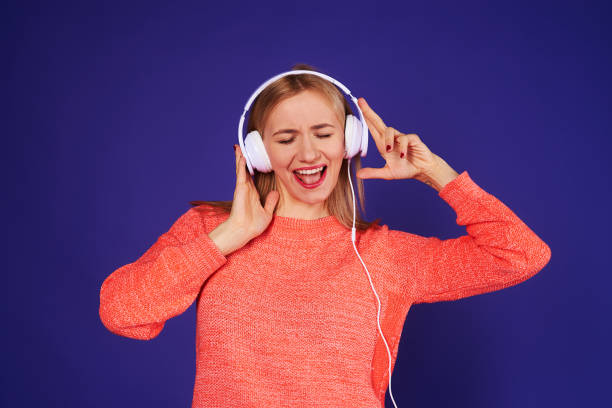 istock young blond enjoying music 917444936