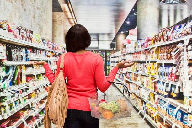 istock Supermarket customer holding basket 917445098