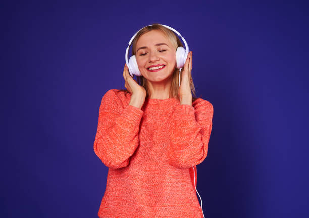 istock happy blond enjoying music in headphones 917445408