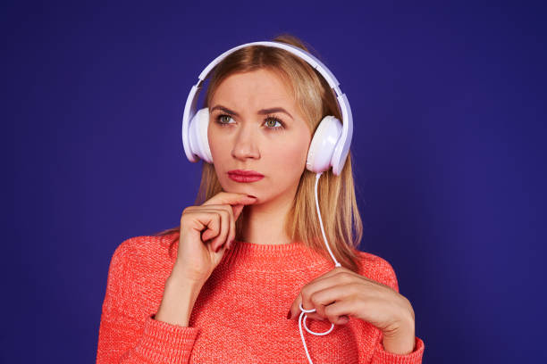 istock thoughtful blond in headphones 917447728