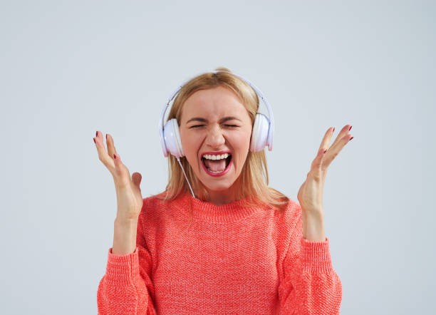 istock blond in headphones screaming 917448560