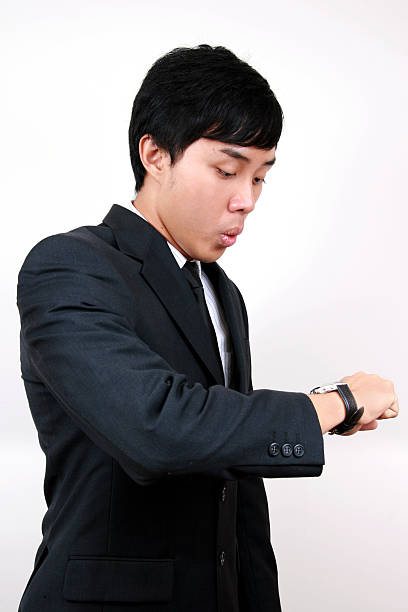 istock Young Asian Business man looking at his watch. 91744957