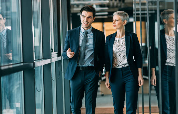 Two business people taking Two business people taking business man looking away stock pictures, royalty-free photos & images