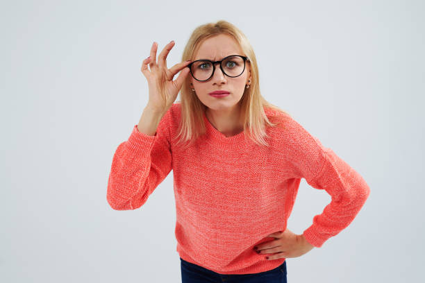 istock funny blond in glasses staring at camera 917450704