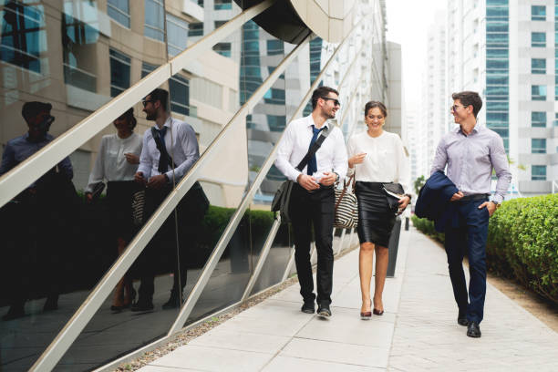istock Group of business people walking talking. 917454898