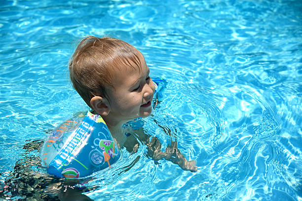 Boy swimming in the pool stock photo